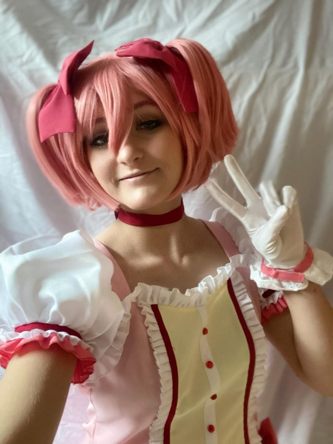 Smiling at the camera, sophomore Maddie Hanna cosplays as Madoka Kaname from the anime series Madoka Magica.