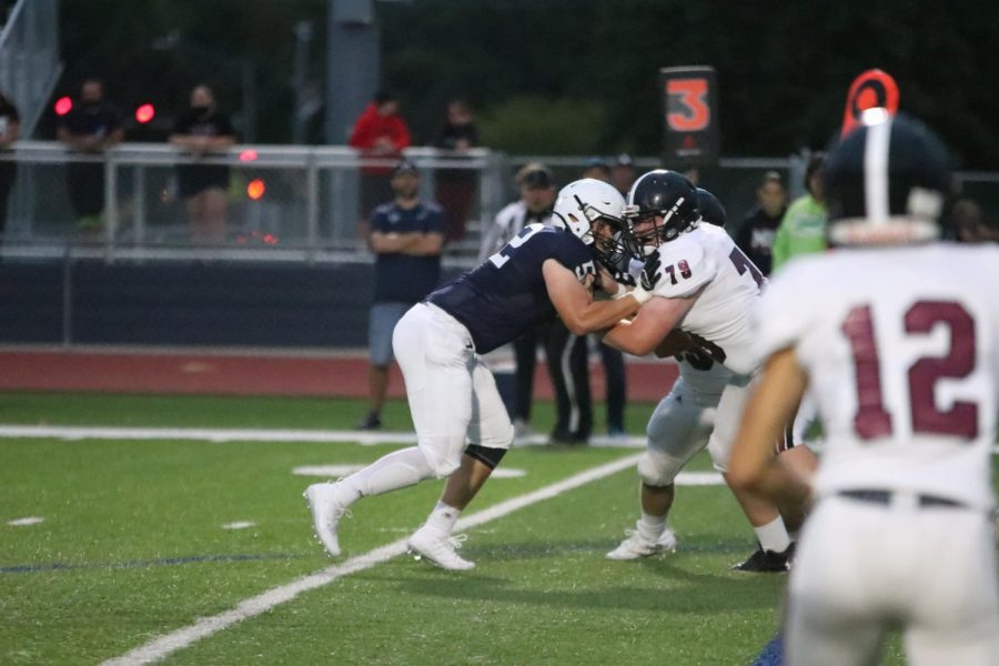 Defensive lineman junior Grant Rutowski drives a Lawrence High  player on the 20 yard line. 