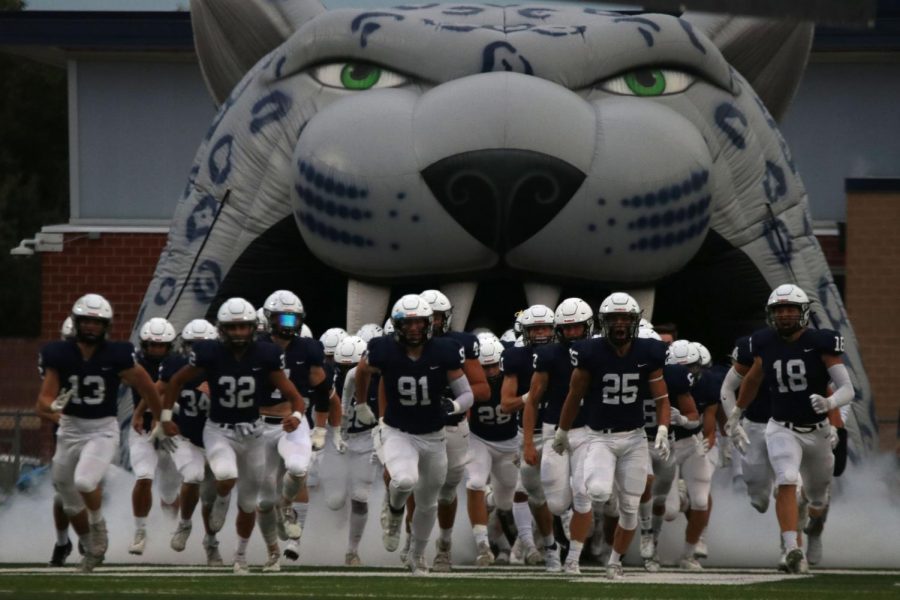 Senior Cody Moore leads the jaguar football team onto the field and into their second home game of the year.