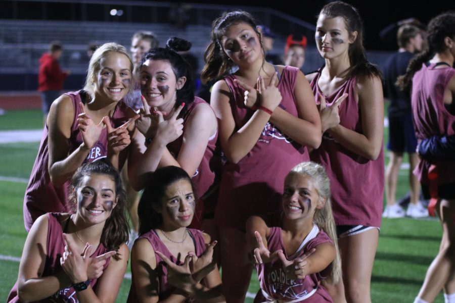 Holding up a “W,” junior girls pose for a picture after their win.