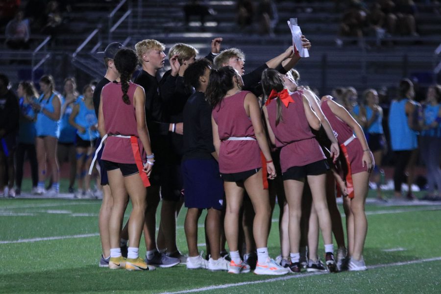 With the playbook in hand, junior Hayden Jay shows the team their next play. 