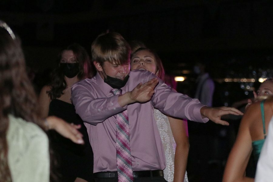 Surrounded by his friends, junior Brody Shulda shows off his dance moves.