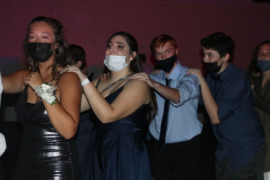 Walking across the gym, juniors Carli Dupriest, Yalena Vega, Andrew Dodge and Bryce Jennings participate in the conga line.
