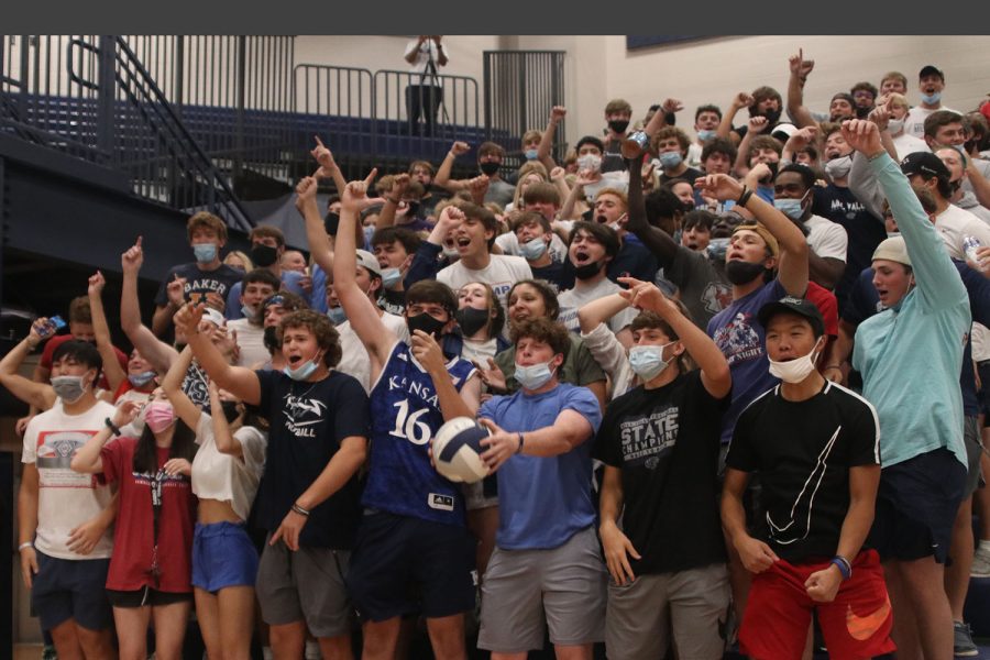 As the team scores the game-winning point, the student section erupts in cheers.