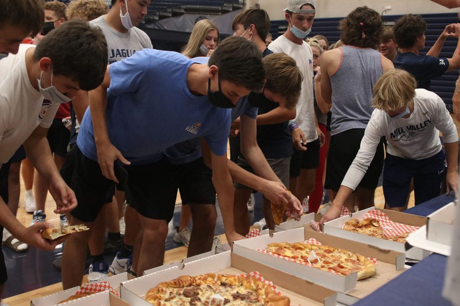 To thank students for cheering their daughters on, volleyball parents bought pizza for the student section.