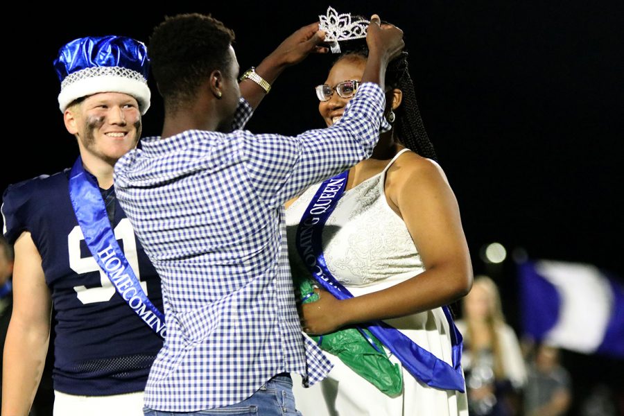 While+the+crown+is+being+placed+on+her+head%2C+Homecoming+queen+senior+Hannah+Hunter+gazes+ahead+at+the+cheering+crowd+Friday%2C+Sept.+24.+Hunter+stands+beside+Homecoming+king+senior+Cody+Moore+as+she+is+being+crowned+by+the+former+Homecoming+king+Quin+Witternauer.+