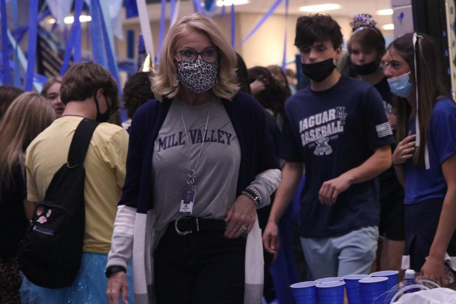 Walking through the main foyer, principal Dr. Gail Holder views the decorations put up by the senior class. 