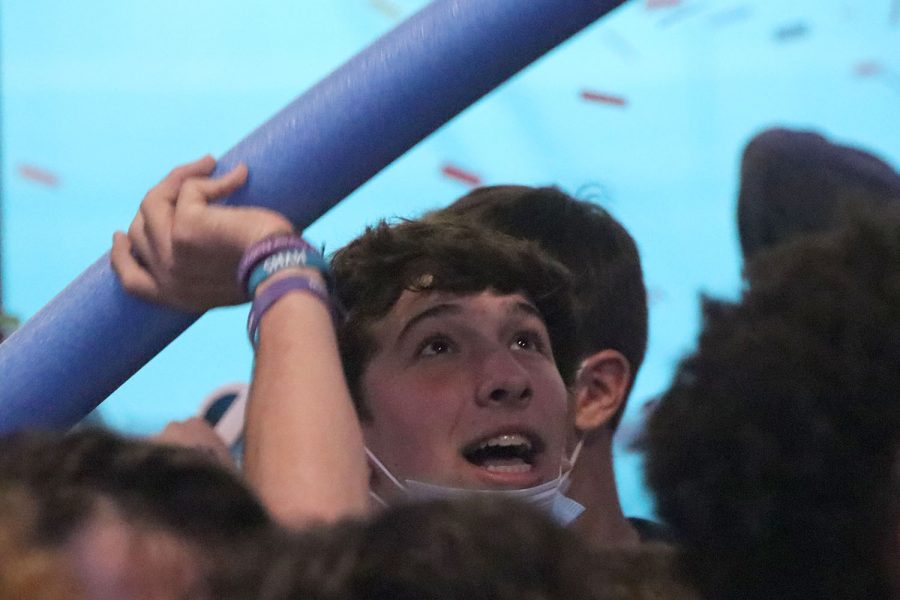 As confetti rains down upon him, senior Jack Weber prepares to throw a pool noodle into the air.