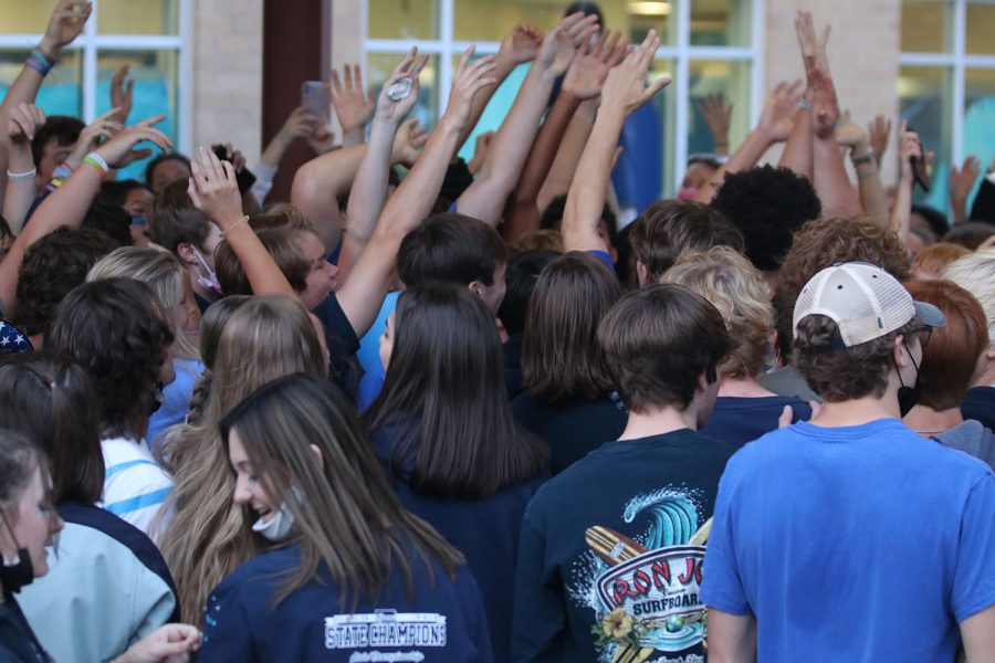 Hands in the air, the senior class dances and sings along to music together.
