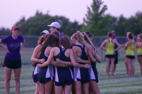 Before reporting to the chute for the start of their race, the JV girls team huddles together.