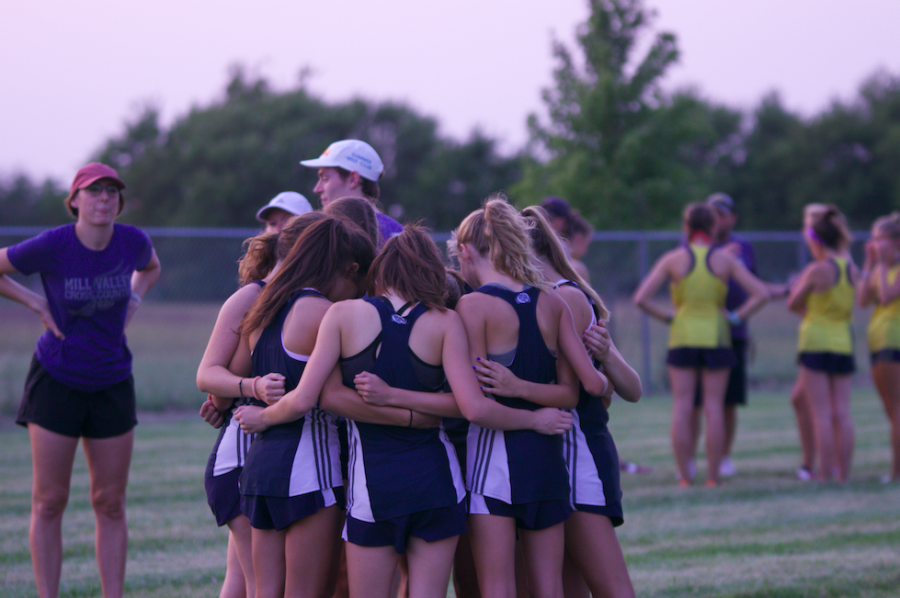 Before reporting to the chute for the start of their race, the JV girls team huddles together.