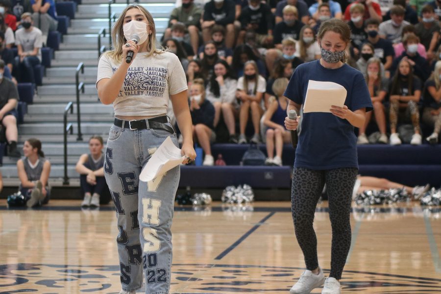 Microphones+in+hand%2C+seniors+Elise+Canning+and+Lauren+Walker+announce+at+the+Homecoming+pep+assembly+held+Friday+Sept.+24.+%0A