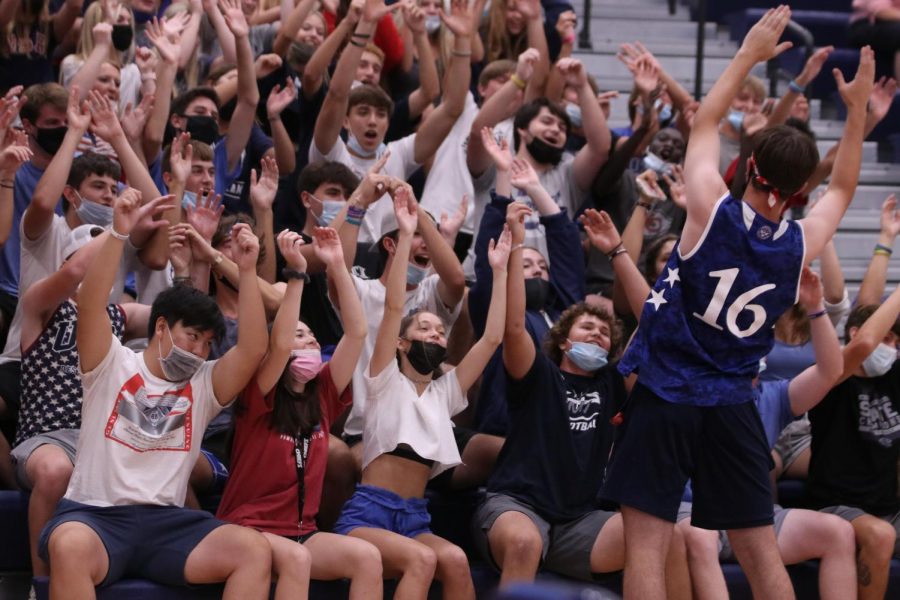 Standing in front of the student section, senior class president Nick Brubeck leads the crowd in the timeless tradition of the rollercoaster.