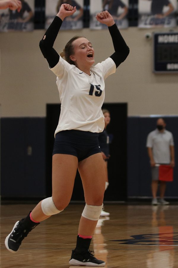 Hands in the air, senior Annabelle Manning celebrates winning a point.