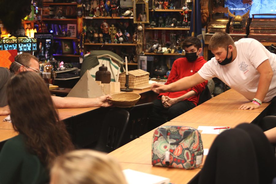 Reaching across the table, junior Jack Melvin tosses another question into the basket.
