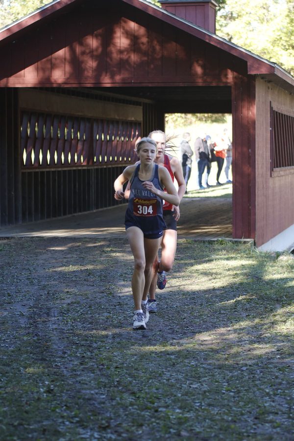 Past the bridge, senior Bridget Roy focuses on the ground while taking a step.