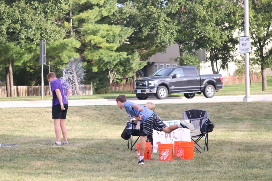 At the “Water the Dog” fundraiser, senior Declan Taylor tries to dodge the water balloons. 