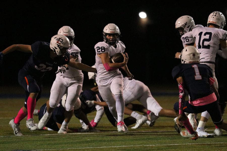 Running the ball down the middle of the field, senior running back Reice Kennedy carries the ball without being tackled.