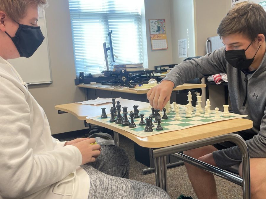 Junior Connor Bauer watches as his classmate, junior Gabe Martin makes his next move