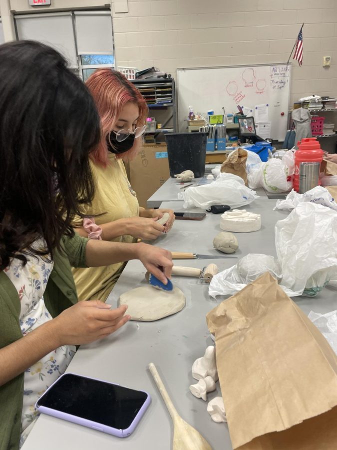 Seniors Dayanara Trevizo and Natalia Hernandez work on their pinch form projects.