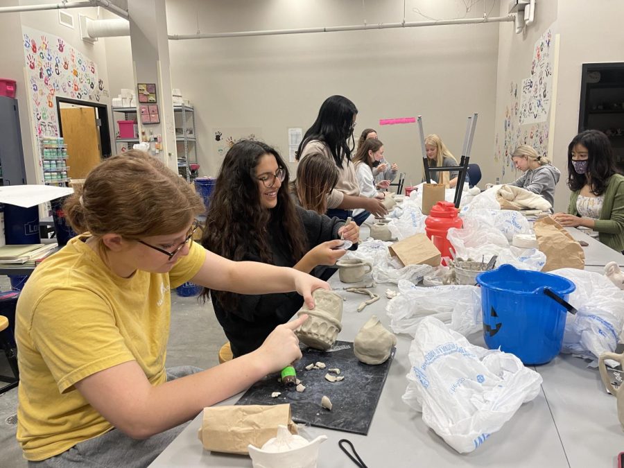 Sophomore Emma Lehn, Senior Leila Garcia along with other students work hard on their pinch form project. 