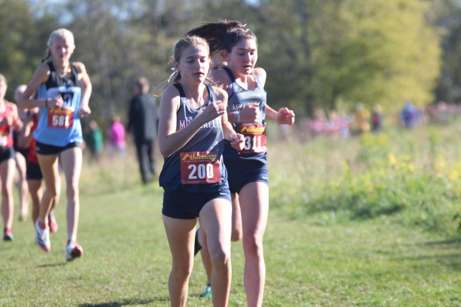 Side-by-side, freshman Meghan McAfee and sophomore Kynley Verdict approach the bend.