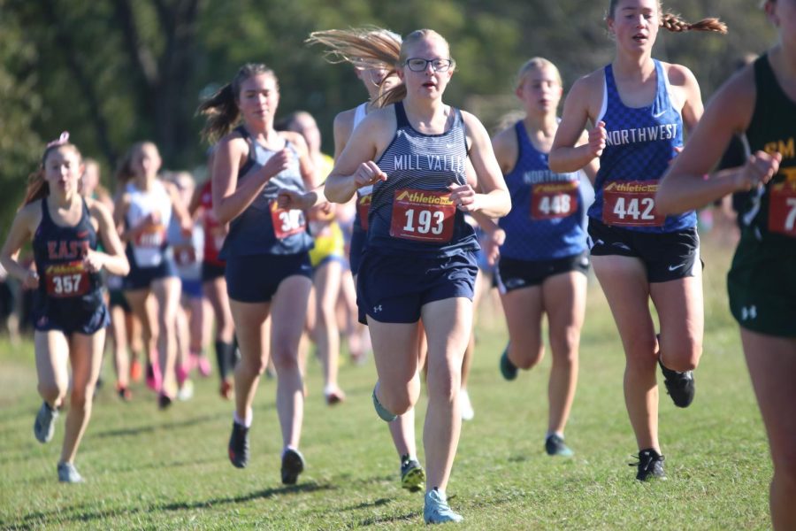 In the early stages of the race, freshman Laura Hickman runs with the group. 