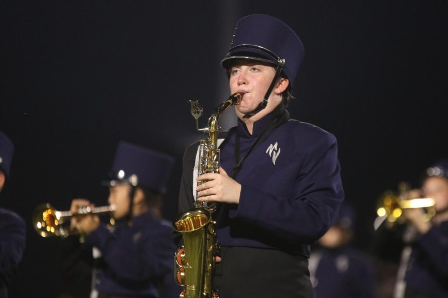 Looking ahead, senior Julianne Long plays her saxophone