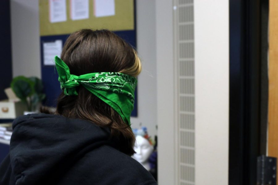 Having just put on her blindfold, sophomore Kaelyn Russell walks out of the psychology classroom.
