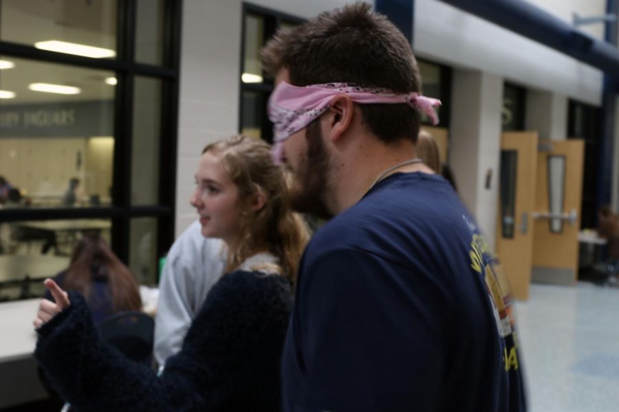  In the main hallway, senior Cole Seyb listens to senior Ashley Sagi’s instructions on where to go.
