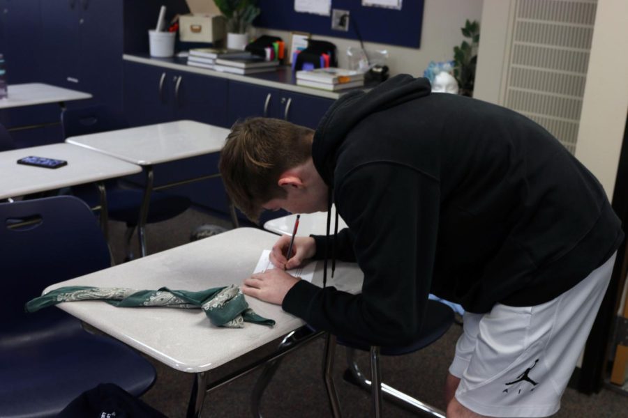 After completing one round with a blindfold, junior Alex Schmidt writes on his reflection sheet.
