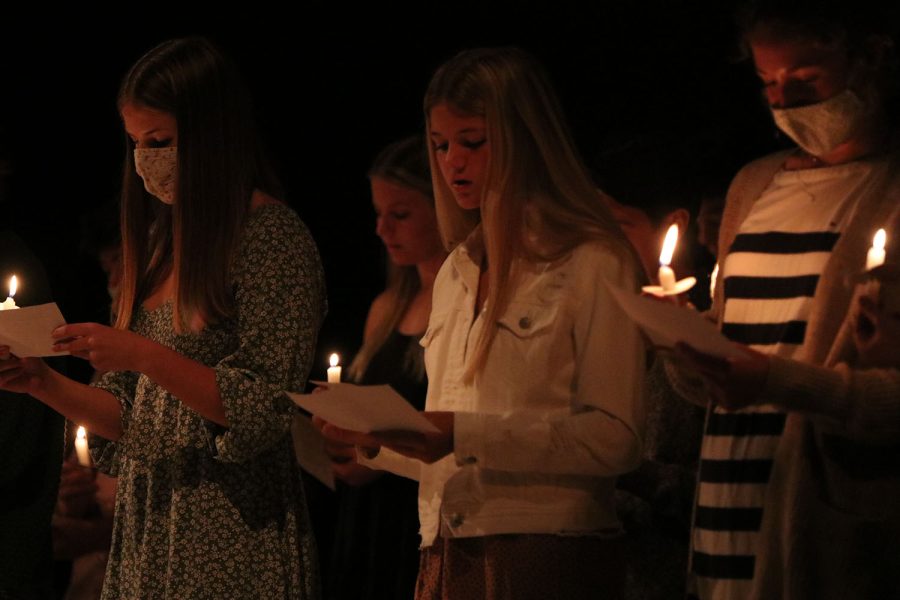 As they hold candles in their hands, Spanish NHS members recite the member oath during the ceremony Wednesday, Oct. 20.