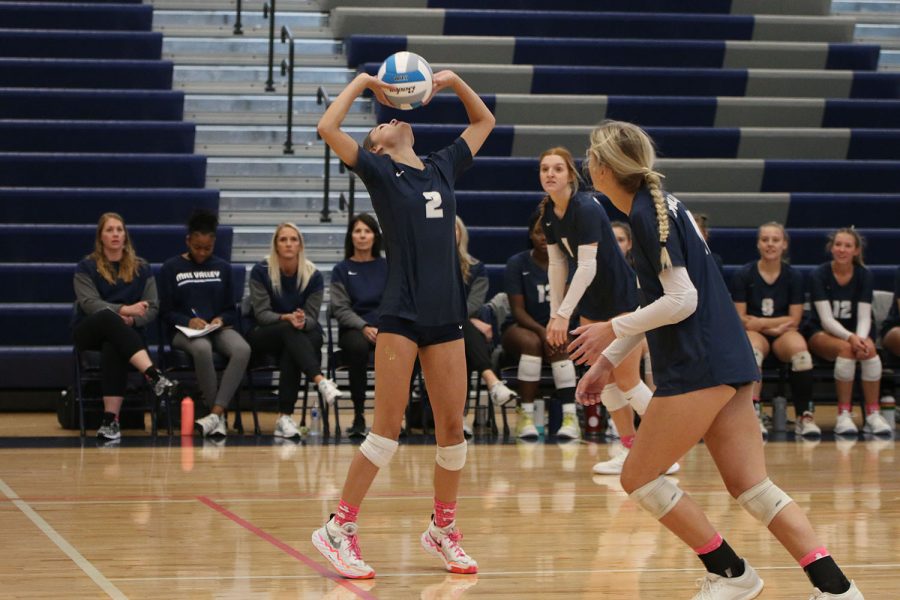 As her teammates prepare to hit the ball, sophomore Ava Jones sets the ball.