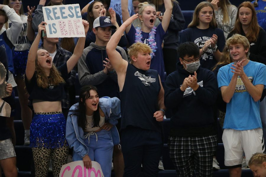 After the girls volleyball team scores a point, the student section cheers.