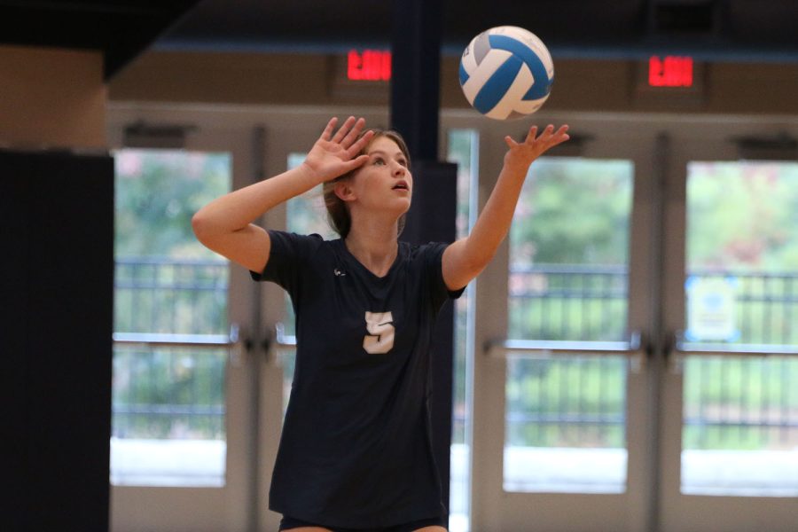 Eyes on the ball tossed in the air, freshman Saida Jacobs gets ready to serve.