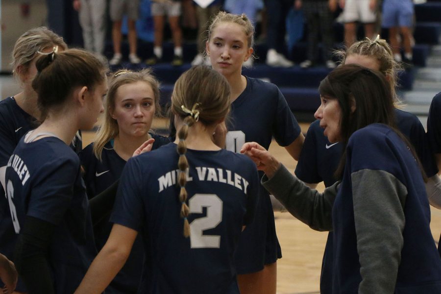 During a time out, head coach Deborah Fay talks to the players about their performance.