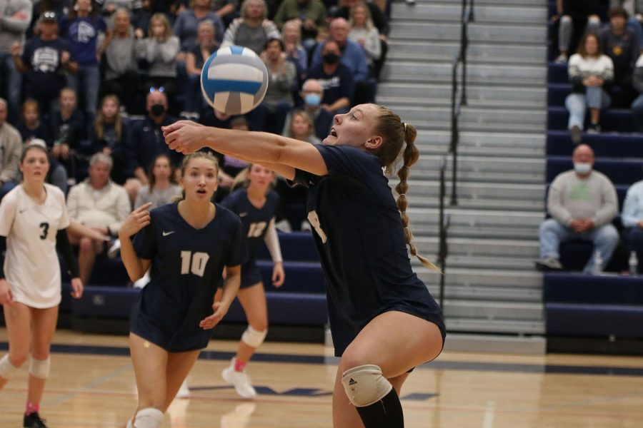 Leaning toward the sidelines, senior Sydney Fiatte passes the ball back to her teammates.