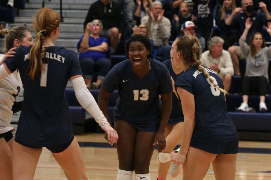 Cheering on the court, senior Taylor Roberts celebrates with the rest of the team after scoring a point.