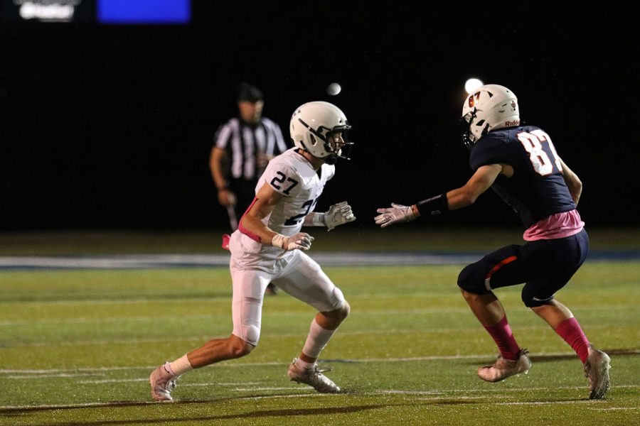 While trying to fake out the opposing player, junior Mikey Bergeron keeps his eye on the quarterback preparing to prevent a gain of yards. 