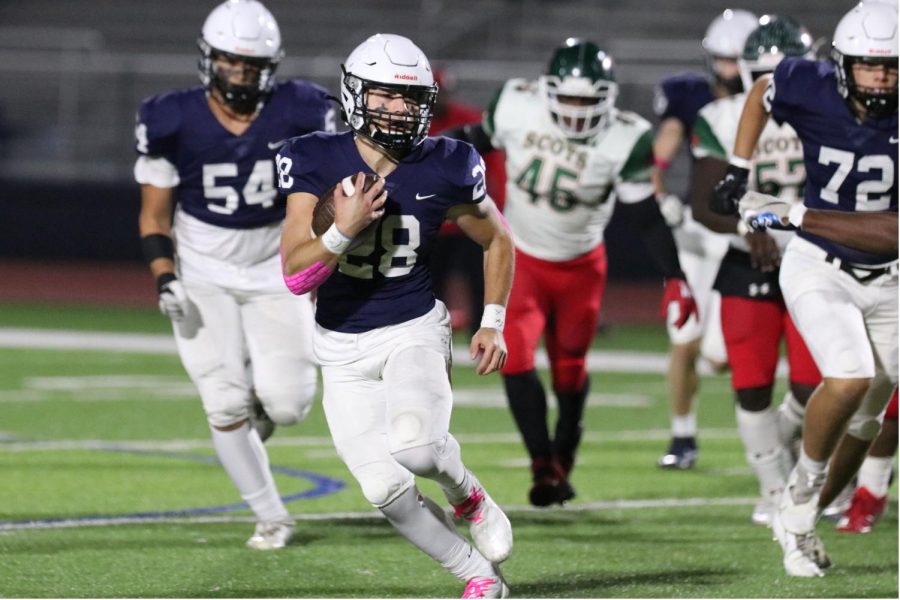 Carrying the ball down field, senior Reice Kennedy holds the ball tightly and dodges the opposing team.