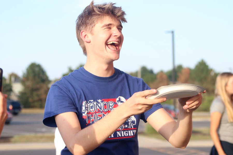 After catching the pancake on his plate, senior Bret Weber begins to cheer. 