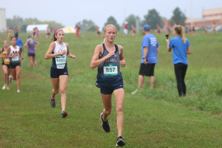 Freshman Charlotte Caldwell continues on after reaching the halfway point of the 3.1 mile race. Caldwell went on to take 16th place with a time of 19:25.