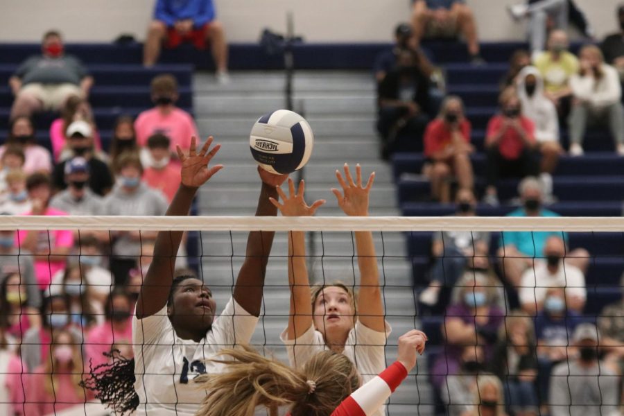 Senior Kate Roth and Senior Taylor Roberts jump up to block the ball.