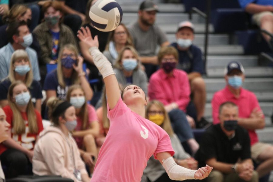 Junior Sidney Kacsir hits the ball to the other side of the court to prevent Shawnee Mission North from scoring.