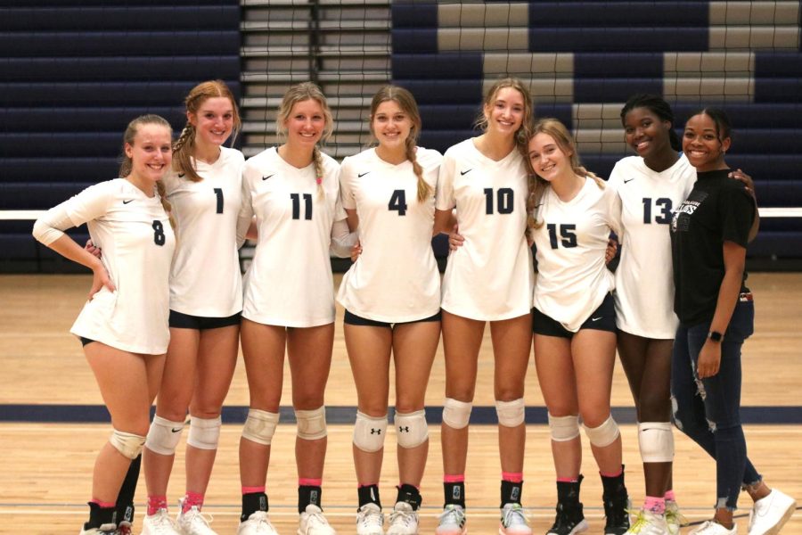 After beating Shawnee Mission North 2-0 in their last home game, all eight seniors gather on the court for a group photo