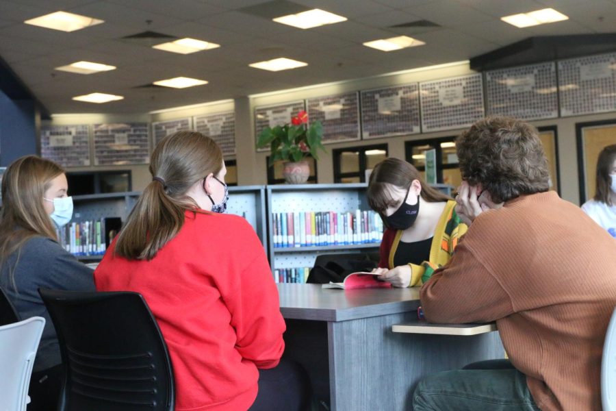 Talking to her small group, sophomore Ryleigh McCall finds a quote in the book that she enjoyed