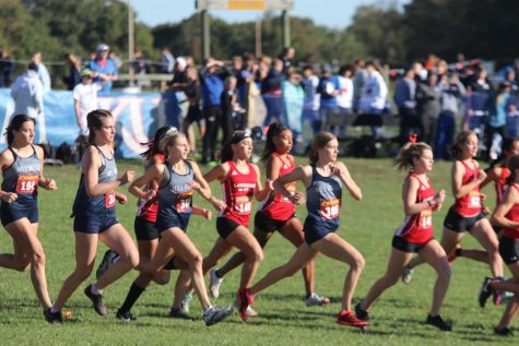The girls cross country team runs off after the starting pistol was shot. The teams ran at Rim Rock Farms Saturday, Oct. 16 for the Sunflower League conference meet, where the boys placed fourth and the girls placed third.  
