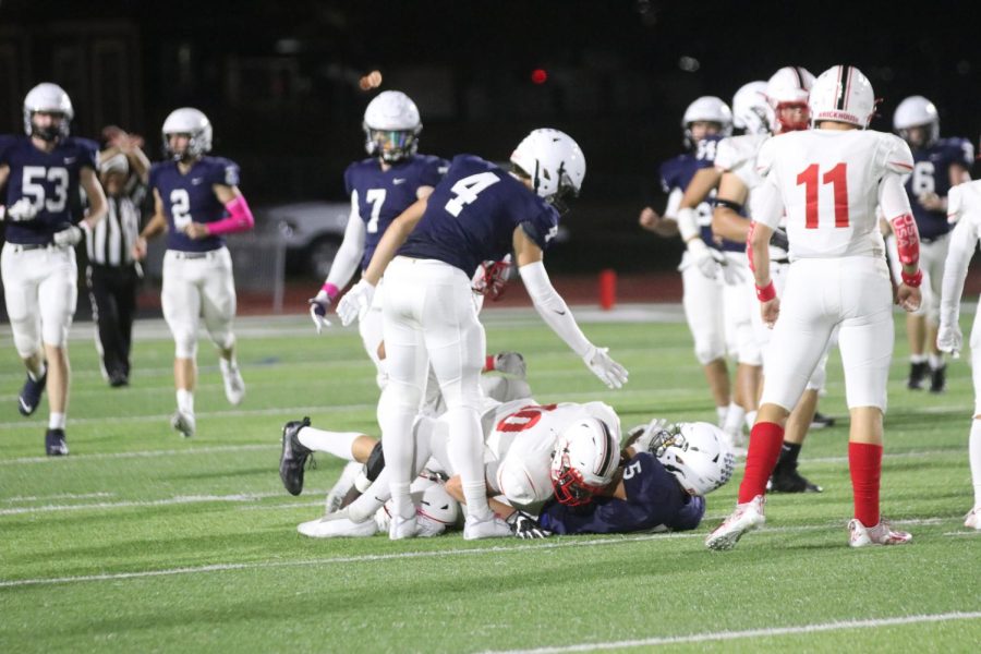 After a tackle was made by Shawnee Mission North, wide receiver senior Sean Allerheiligen offers a hand to tight end senior Kendrick Jones