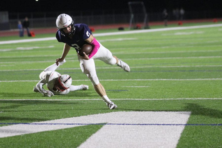 About to score a touchdown, quarterback junior Hayden Jay rushes the in-zone. 