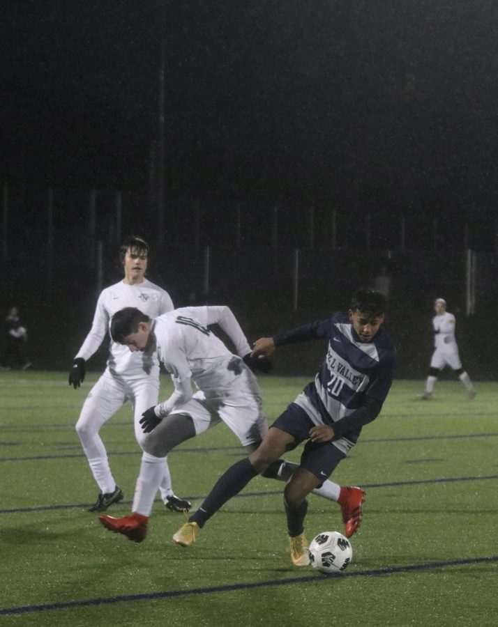 As his opponent runs with the ball, senior Harrison Bensouda steals the ball.